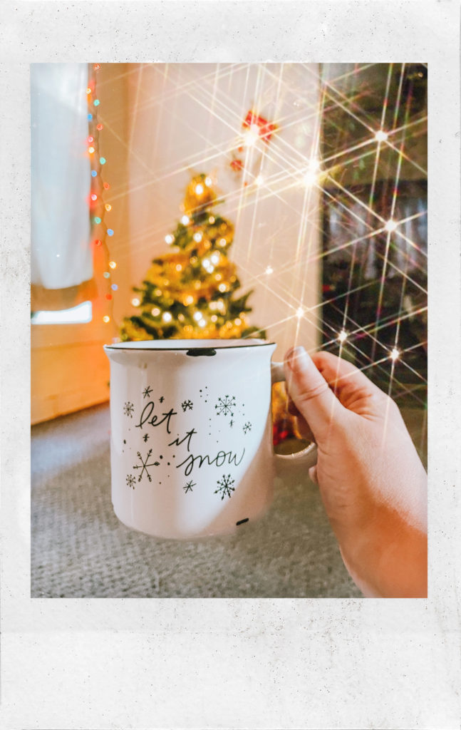 Coffee mug reading Let It Snow in front of a Christmas tree. Behind the scenes at Anna Gutermuth Photography.