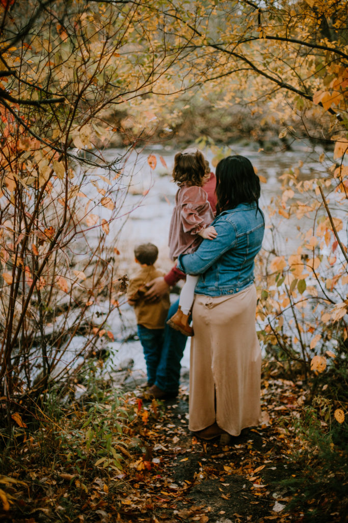 Family stands watching the river at Jordan Park in Stevens Point. Anna Gutermuth Photography, Year in Review 2022.