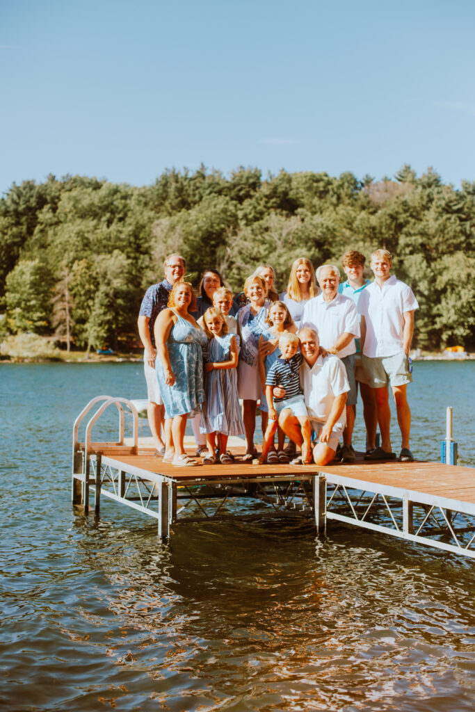 Group of people standing on the dock during their Long Lake extended family session.