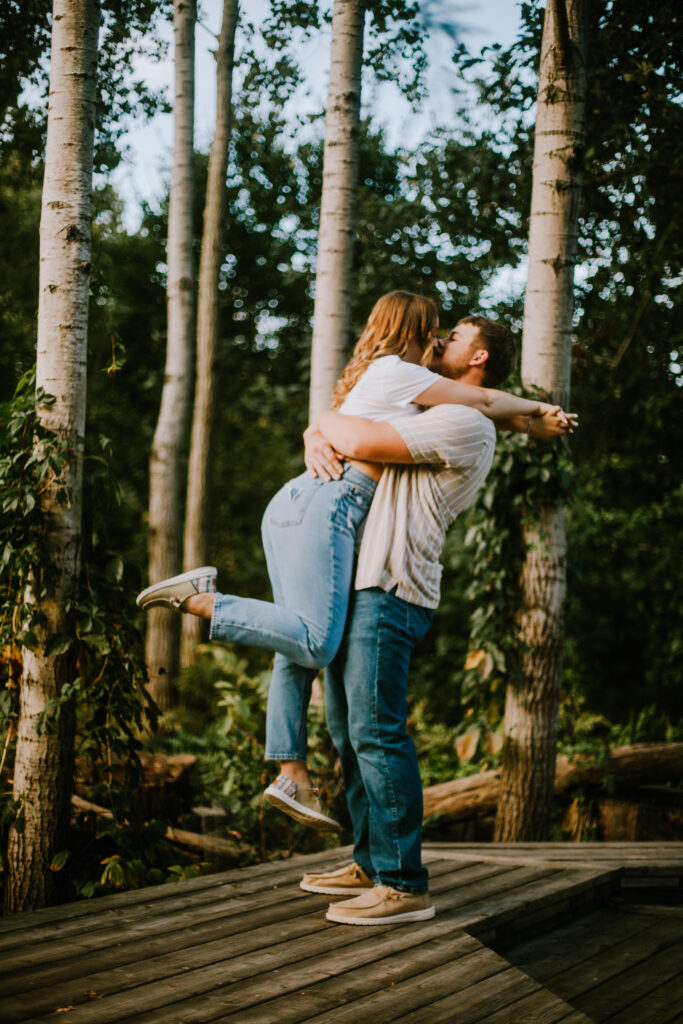 Couple kissing during their engagement session at Olbrich Botanical Gardens in Madison, WI.