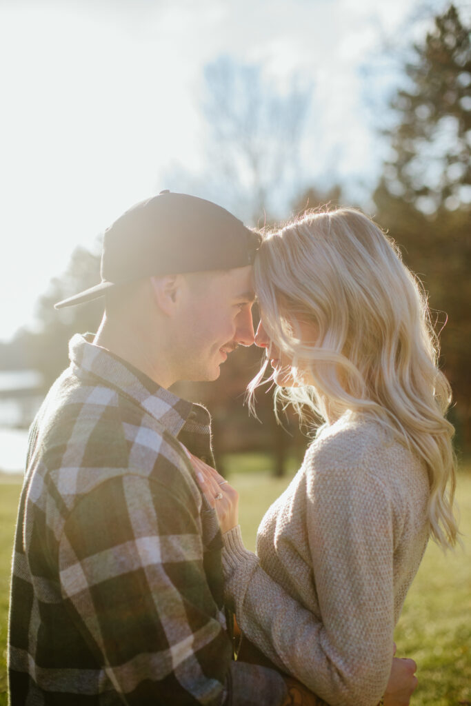 Couple holds each other close during their engagement session at South Park in Waupaca, WI.