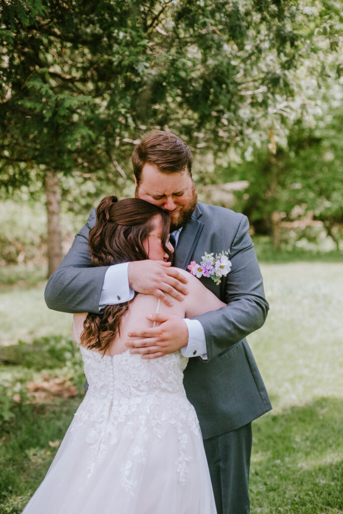 Groom tearing up during the first look with his bride during their wedding day at High Cliff State Park.