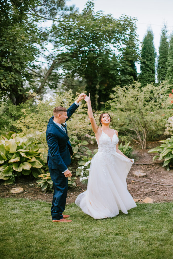 Couple twirling in the garden to kick off 2025 Year in Review: Wedding Edition